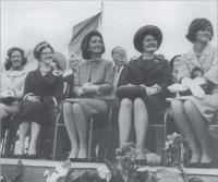 The President's wife, Jacqueline (centre) and his sister, Jean, now US Ambassador to Ireland (right) on the review platform at New Ross. The protocol division of the Dept. of External Affairs made known its displeasure at the original proposal to build one to accomodate 2,000 people, with an admittance charge of ten shillings.