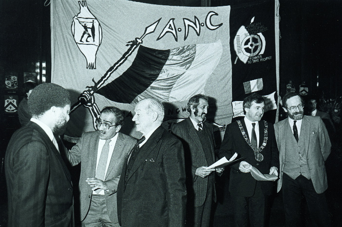 Lord Mayor Bertie Ahern, flanked by actor Ger O'Leary (right) and ANC representative Aziz Pahad (left), hosts a celebration of the ANC's 75th anniversary in Dublin's Mansion House in December 1986. To the left is the Nigerian ambassador in conversation with Kader Asmal and actor Cyril Cusack. (An Phoblacht)