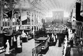 View of the interior of the 1882 National Exhibition. Note the ‘Irish banners and shields of the counties, provinces and towns of Ireland’ (detailed right) hanging on either side of the hall. (Trinity College, Dublin)