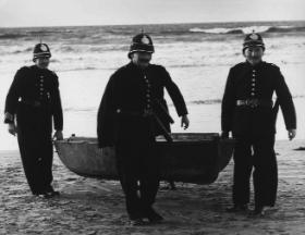 RIC constables seize a small boat found at Banna Strand, Co. Kerry, following the landing of Sir Roger Casement. (RTÉ Stills Library)