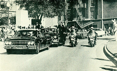 Seconds before the fatal shooting-the presidential cavalcade enters Dealey Plaza. (James Altgens)