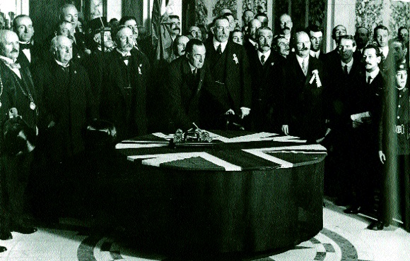 Sir Edward Carson signing the Solemn League and Covenant in Belfast City Hall, 28 September 1912; this declared that ‘Home Rule would be disastrous to the material well-being of Ulster as well as to the whole of Ireland’. While hinting at a partitionist mindset, Carson was pursuing a logic that if ‘Ulster’ succeeded, Home Rule would be dead. But what or where was ‘Ulster’? (George Morrison)