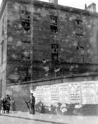 A soldier guards British Army recruiting posters on a wall of the battered Four Courts in the wake of the Rising. (TopFoto)