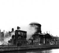 The Four Courts under bombardment. The explosion that ripped through its Public Record Office on 30 June 1922 destroyed much of Ireland’s documentary heritage dating back to the early thirteenth century. (RTÉ Cashman Collection)