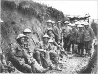 A ration party of the Royal Irish Rifles resting in a communications trench at the Somme, July 1916.