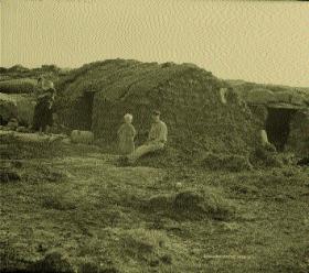 Right: The same family standing outside a sod-built hut also at Gweedore, Co. Donegal, c. 1887. (National Photographic Archive)