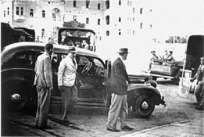 Tegart (centre, emerging from car) in Palestine, c. 1937-8, with Sir William Battershill (right), chief secretary to the government of Palestine. (Bodleian)