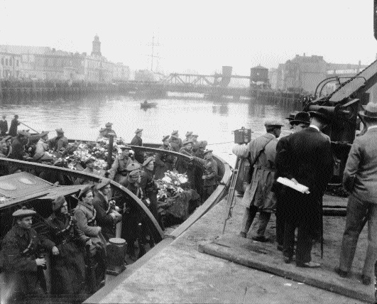 Auxiliaries guard the body of Terence MacSweeney as it is returned to Cork harbour, where he was lord mayor, following his death on the seventy-fourth day of hunger strike in Brixton prison, 25 October 1920. That information comes from the caption of an almost exactly similar photograph (taken by the same photographer?) reproduced on the bottom left corner of page 258 of Brian de Breffny (ed.), The Irish World: the history and cultural achievements of the Irish people (Thames and Hudson 1977).