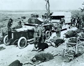 An armoured car and wounded on stretchers waiting to be evacuated from Guilemont, September 1916. (Imperial War Museum)