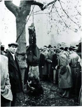 A secret police colonel hanged by the feet. (Erich Lessing, Magnum)