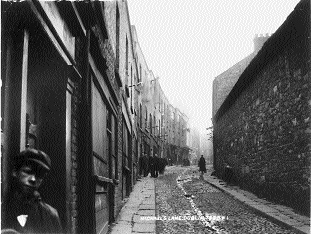 Tenements in Michael's Lane. Turn-of-the-century Dublin was notorious for its overcrowded and unsanitary tenements, which bred infectious disease.