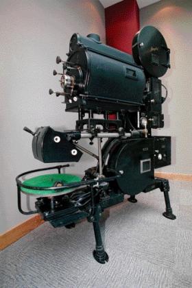 The Vitaphone projector was to first to provide synchronised sound for a motion picture. A vinyl disc of the soundtrack was placed on the turntable (bottom left in the picture).