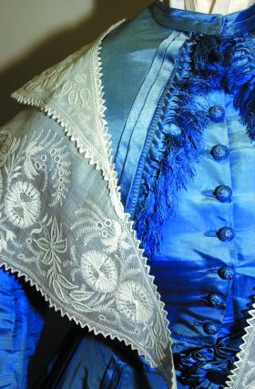 Detail of a Victorian dress (c. 1870), one of the many costumes and uniforms on display.