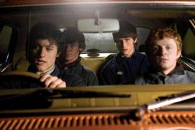 Seventeen-year-old UVF man Alastair Little (Mark Davison, back seat to the right) is driven to the scene of the crime in Lurgan in October 1975.