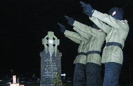 Members of the Continuity IRA firing a volley of shots over the grave of Dan Keating on what would have been his 106th birthday, 2 January 2008. (Wikipedia)