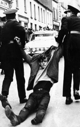 A protesting St Columb’s College student is dragged away by the RUC to Victoria Barracks on Strand Road on 5 October 1968.