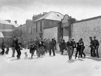 On 13 August 1934, c. 3,000 Blueshirts protested in Cork city against cattle seizures resulting from the non-payment of annuities and rates. Marsh’s Yard, where the cattle were being held for sale, was the focus of the protests. Fifteen Blueshirts drove a lorry through the police cordon and the closed yard gate, followed by a small group on foot. Armed Special Branch detectives inside the yard opened fire, injuring six and killing 22-year-old Michael Patrick Lynch from Carrignavar, Co. Cork. Uniformed Gardaí clashed with hundreds more protestors outside the gates. Lynch became a Blueshirt martyr. Thousands of uniformed Blueshirts attended his funeral, where leader Eoin O’Duffy delivered the oration. (Cork Examiner)