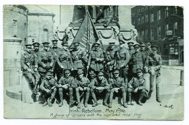 Lt. Dick Burke MC, 3rd and 6th Royal Irish Regiment, from Dingle, Co. Kerry, fought at Wijtschate in June 1917. He also fought in the Easter Rising in 1916 and is pictured here (extreme right, standing) in front of the Parnell monument with a group of British Army officers. Note the captured Sinn Féin flag taken from the GPO. 