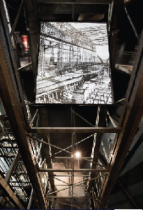 The lift of the reconstructed Arrol gantry and (on screen) the original that surrounded the hull during construction.