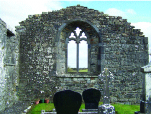 Interior of the east gable of Kilcorban friary. The window has been reconstructed but features cusped tracery, triangular stone points used for decorative purposes.