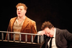 The young Behan (Peter Cooney) in the dock, while the older and wiser Behan (Gary Lydon) looks on.